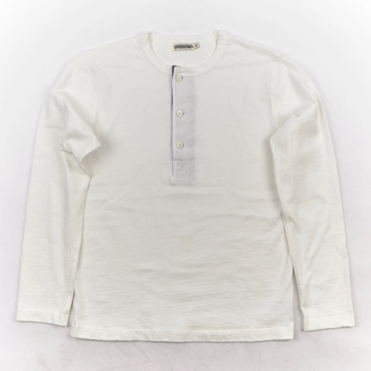 Men's white 13-ounce long-sleeve Henley shirt by Freenote Cloth, shown flat with buttons and ribbed cuffs.