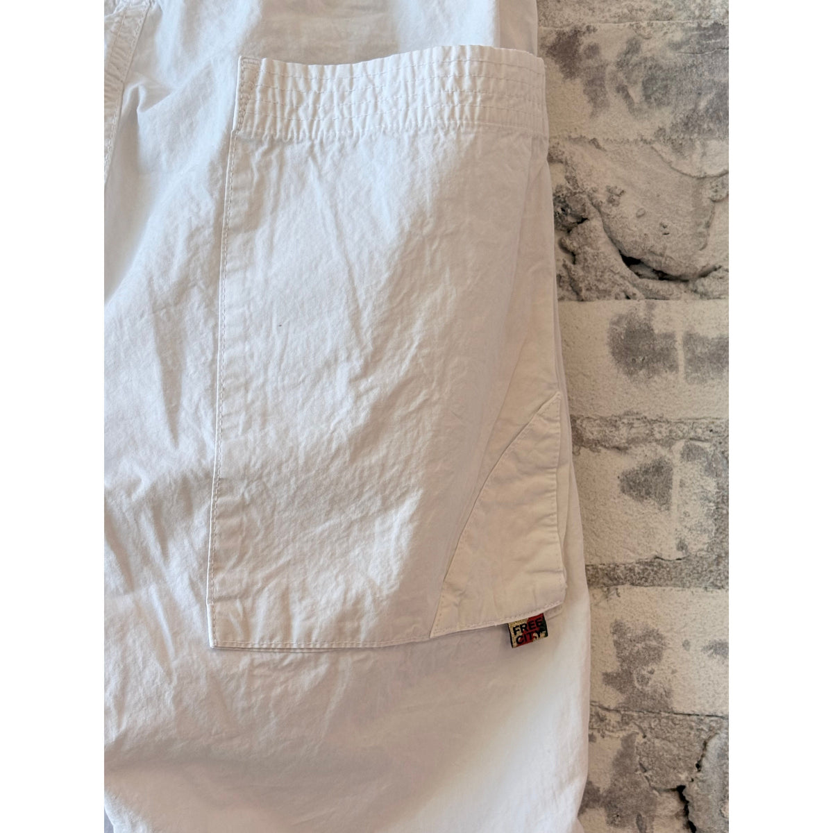 Women's white Homestud Outofsight Poplinair Flapsnap Kite Pants by Freecity, featuring a relaxed fit and stylish design.