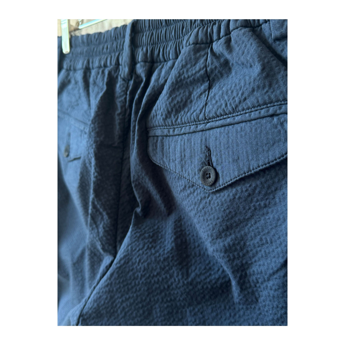 Men's navy seersucker Bermuda shorts with a relaxed fit and textured fabric, ideal for casual summer wear.
