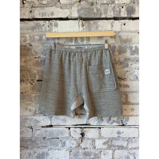 Men's Kepani Raffy fleece sweat shorts in light gray, showing the soft fabric, relaxed fit, and drawstring waistband.