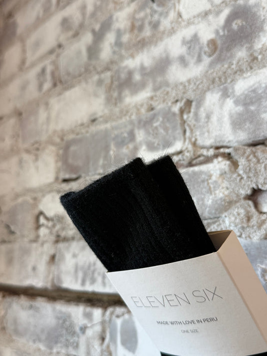 Women's black Ali Ribbed Socks by ELEVEN SIX, featuring a snug ribbed texture and classic black color.