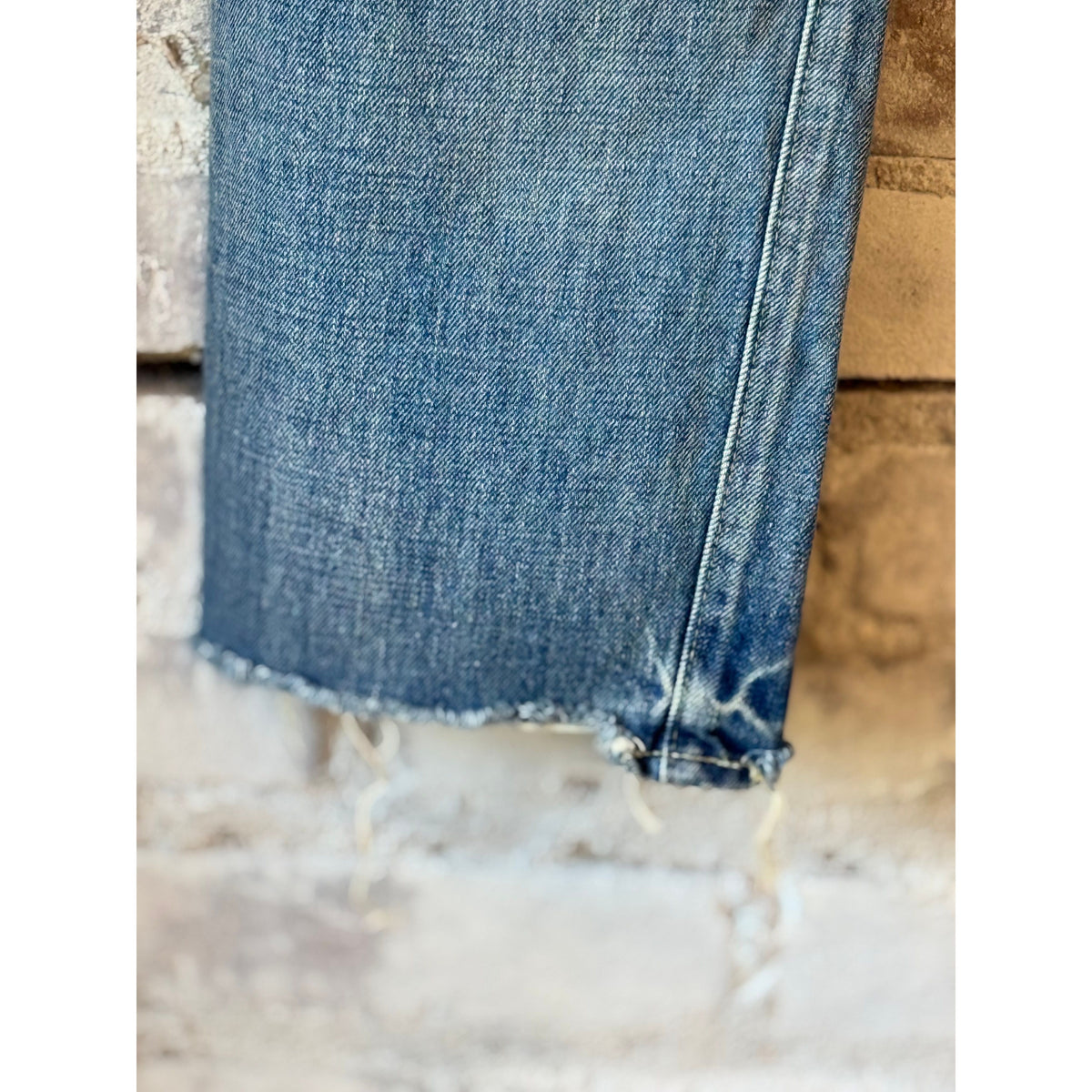 Women's 13.5oz Chimala selvedge denim ankle jeans with medium distress, showcasing a fitted silhouette and distressed details.