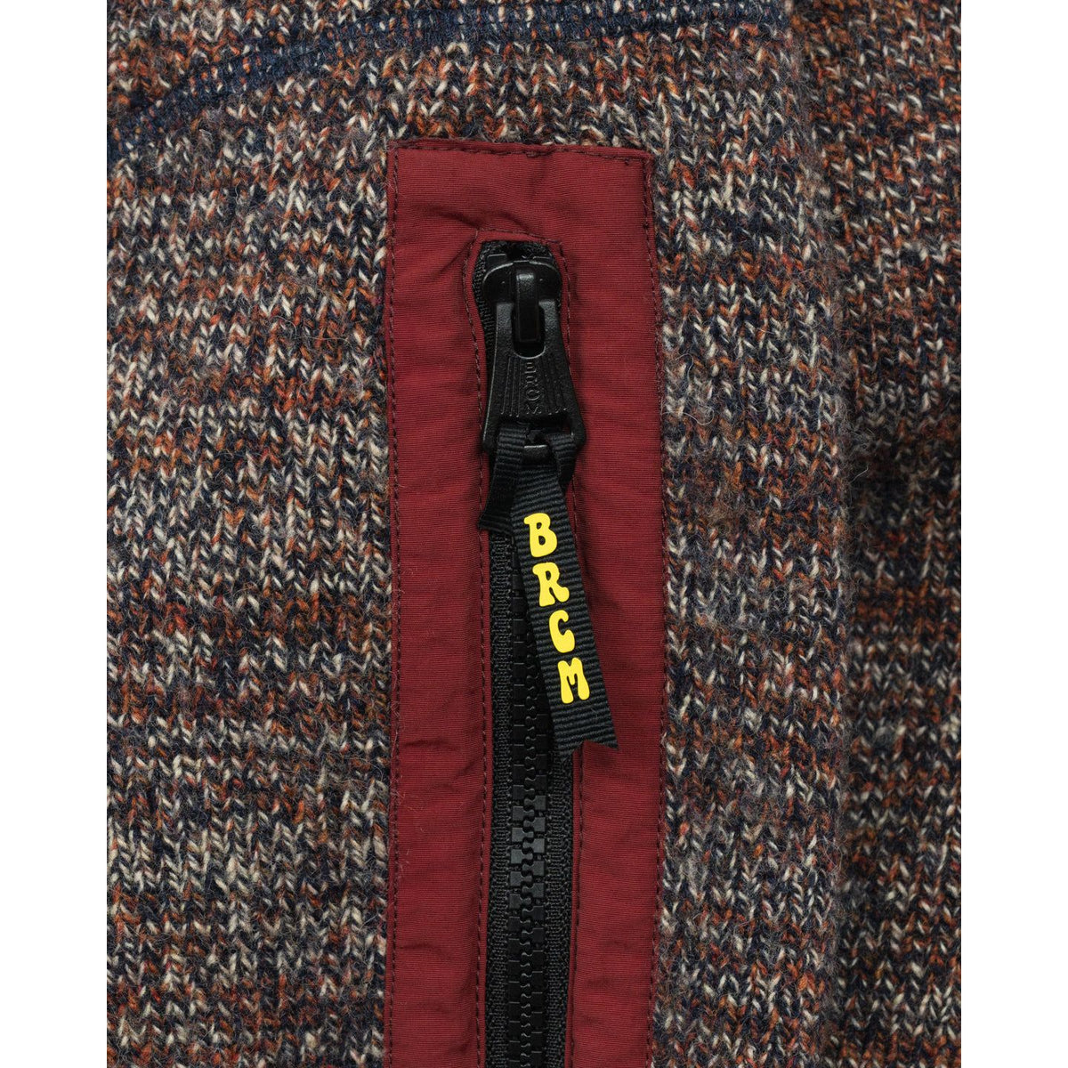 Men's Metanoia Sweater in Passion Fruit by Big Rock Candy Mountaineering, showing a vibrant knit sweater with a textured pattern.