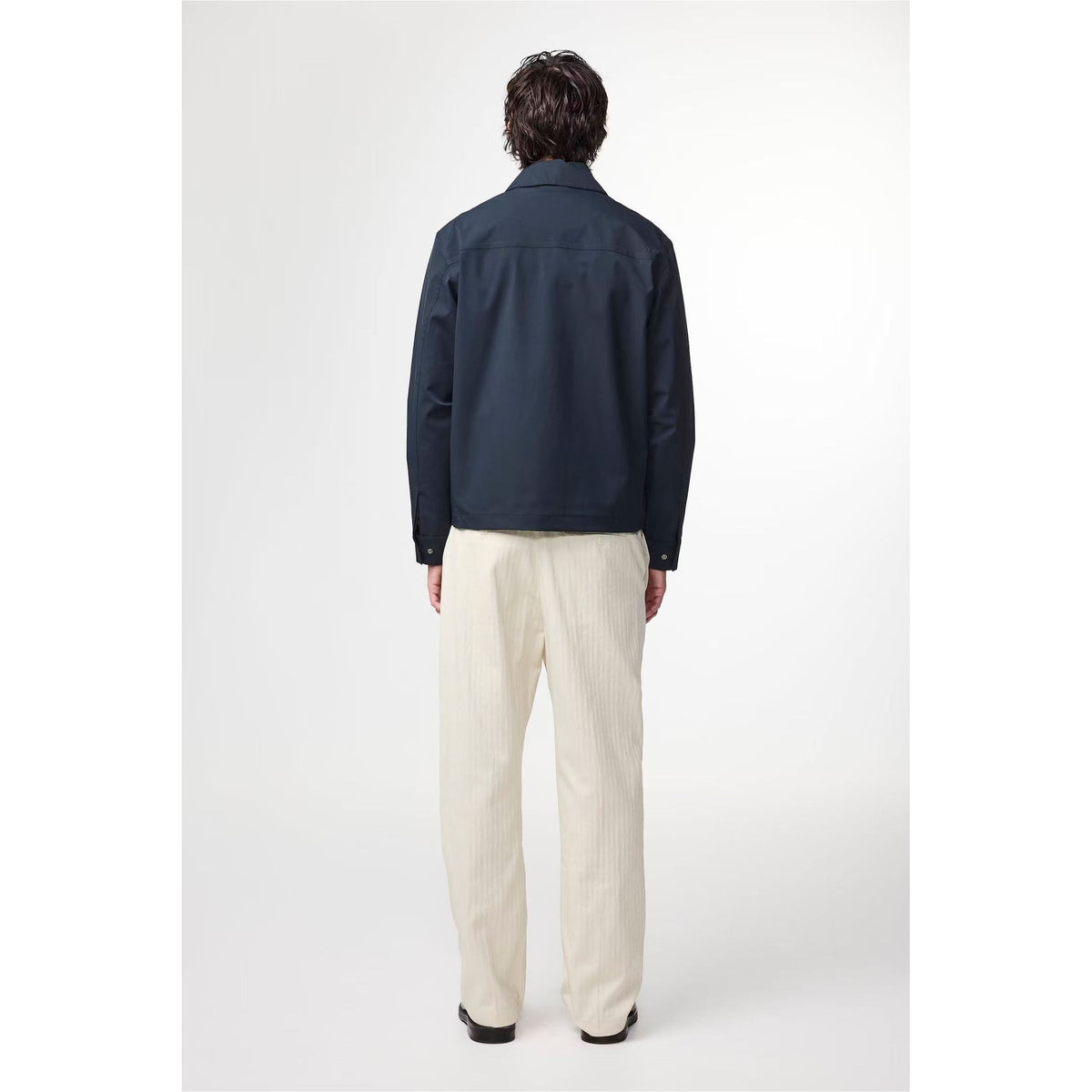 Men's navy blue Alban Technical Jacket by NN07, featuring a sleek design with technical fabric and zipper pockets.