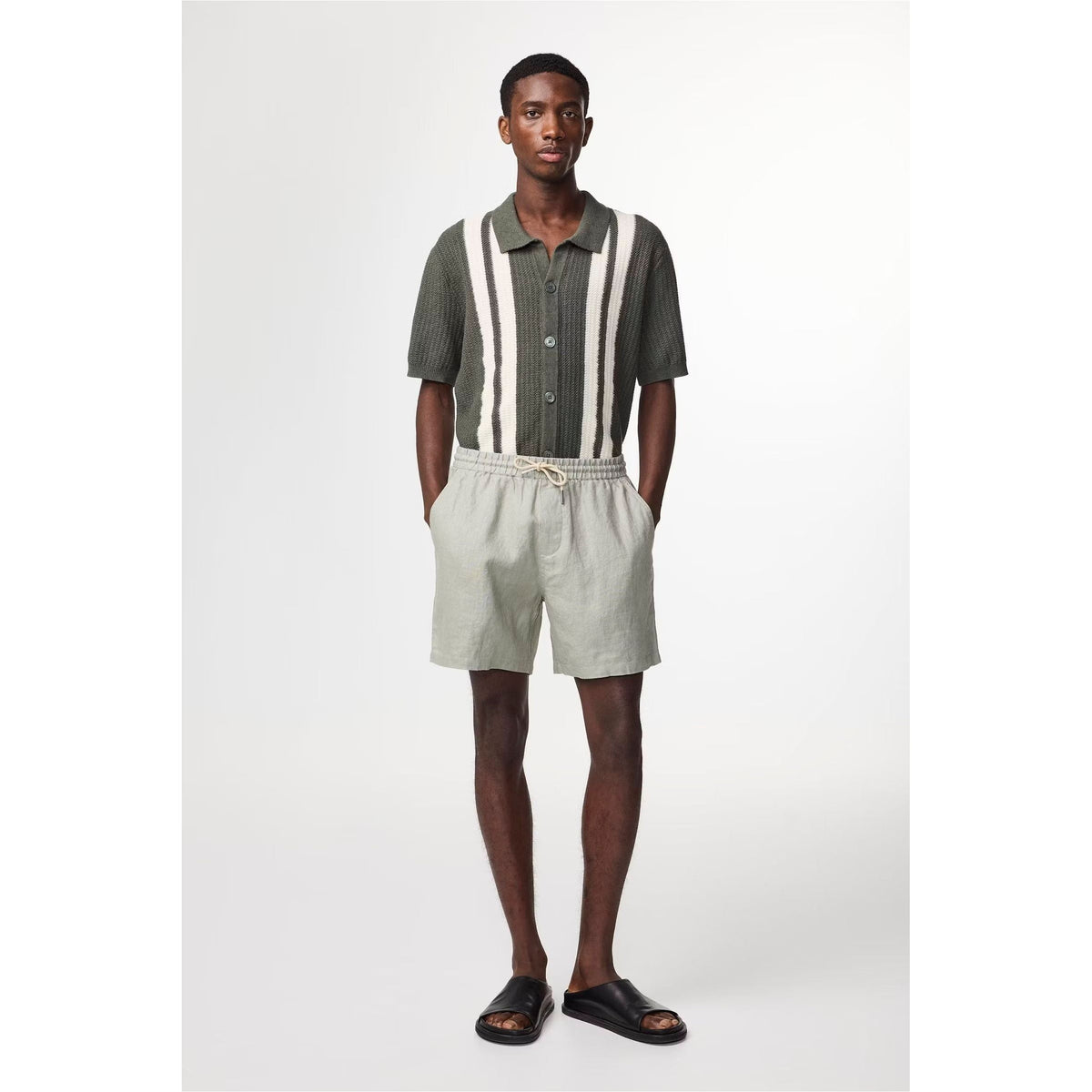 Men's NN07 Gregor casual linen shorts in sage green with drawstring waist, laid flat showing relaxed fit and lightweight fabric.