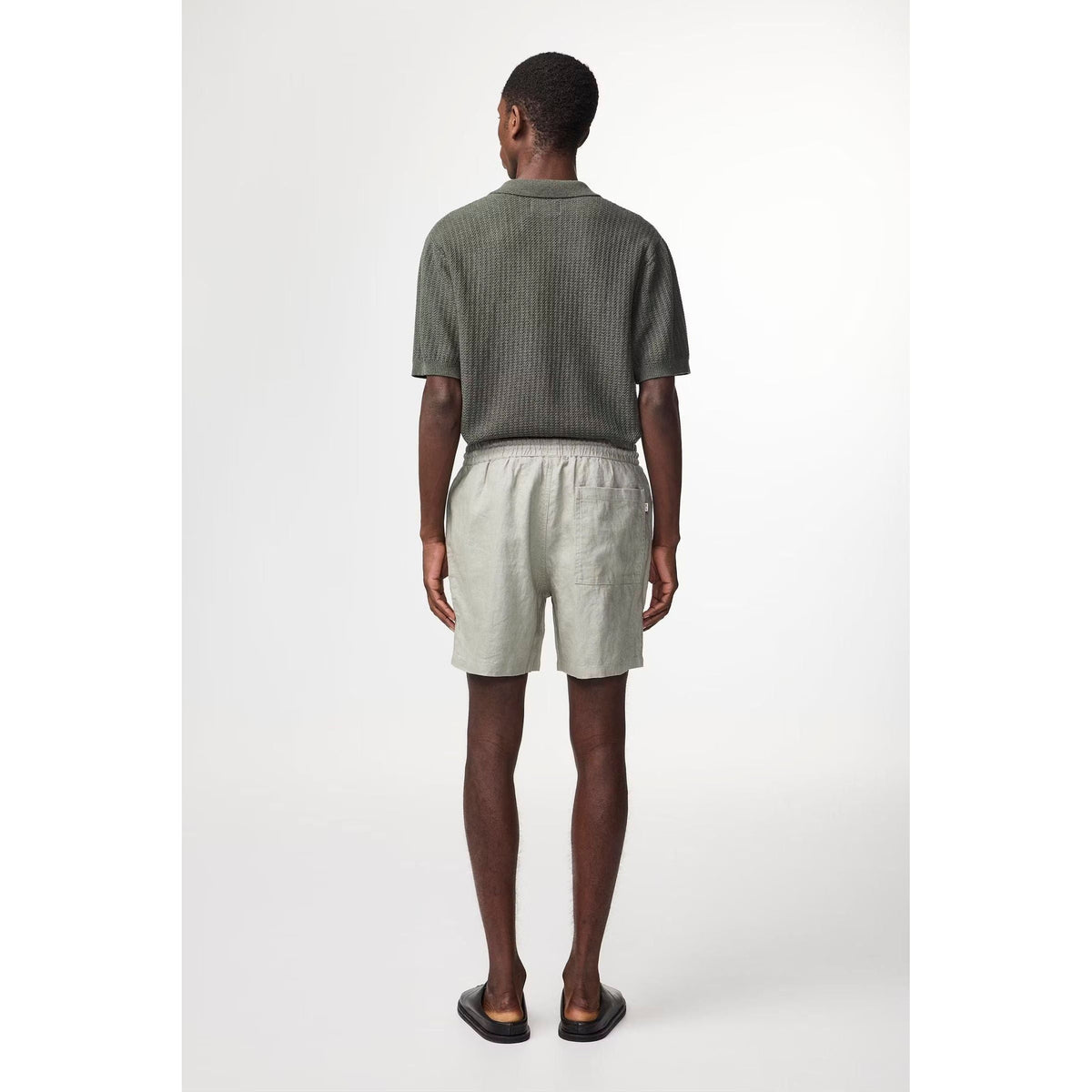 Men's NN07 Gregor casual linen shorts in sage green with drawstring waist and relaxed fit, displayed on a hanger.