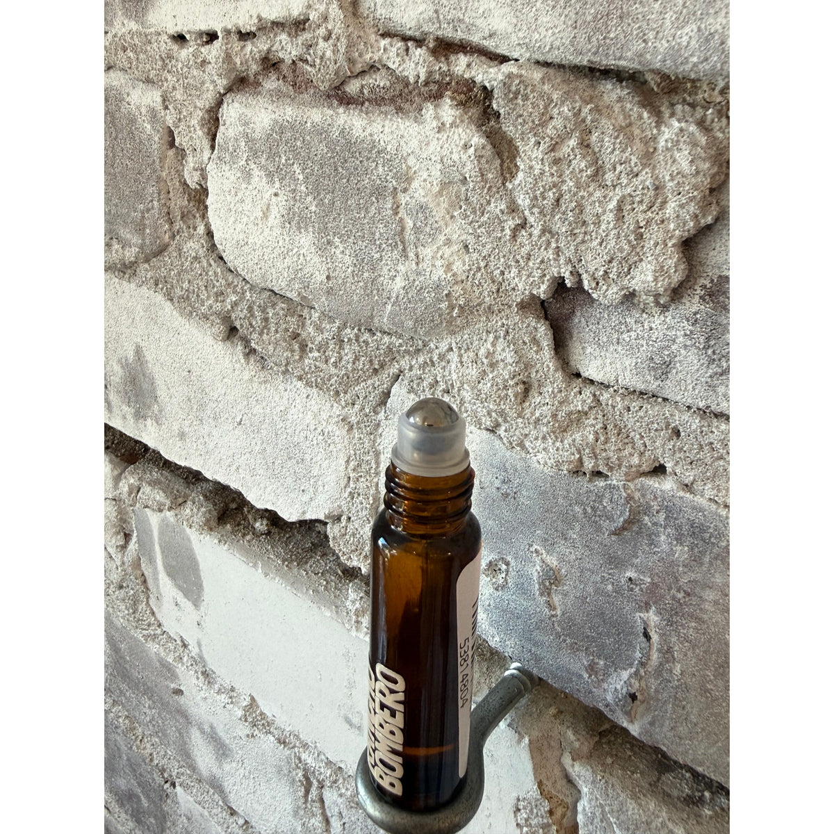 Rancho Bombero scent roller accessory with a sleek, compact design for easy fragrance application.
