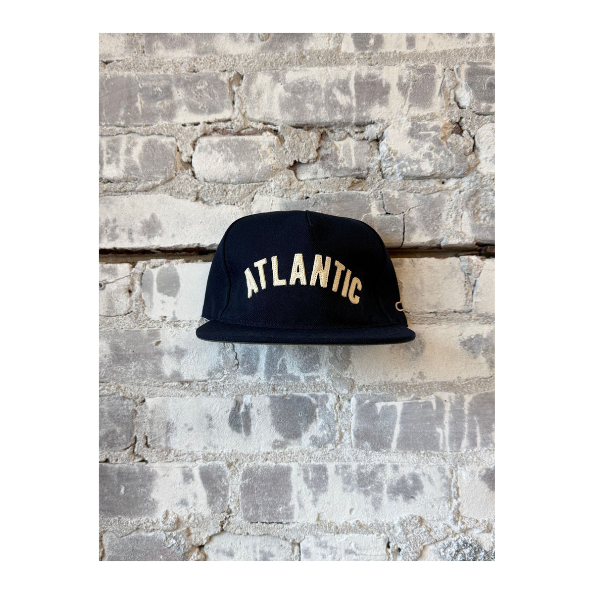 Men's navy Atlantic Snapback hat by The Ampal Creative, featuring a structured crown and adjustable flat brim.
