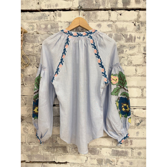 Light blue women's Elysian Whisper blouse by Annabo, featuring a soft fabric and elegant fit, shown on a mannequin.