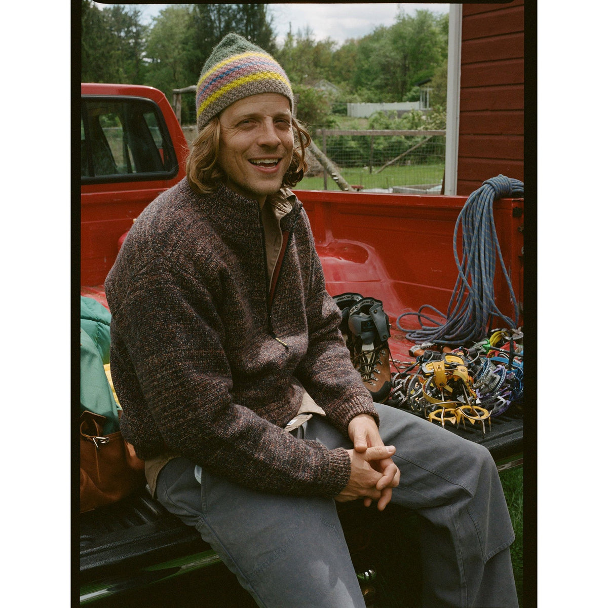 Men's Metanoia Sweater in Passion Fruit color by Big Rock Candy Mountaineering, showcasing the vibrant knit fabric.
