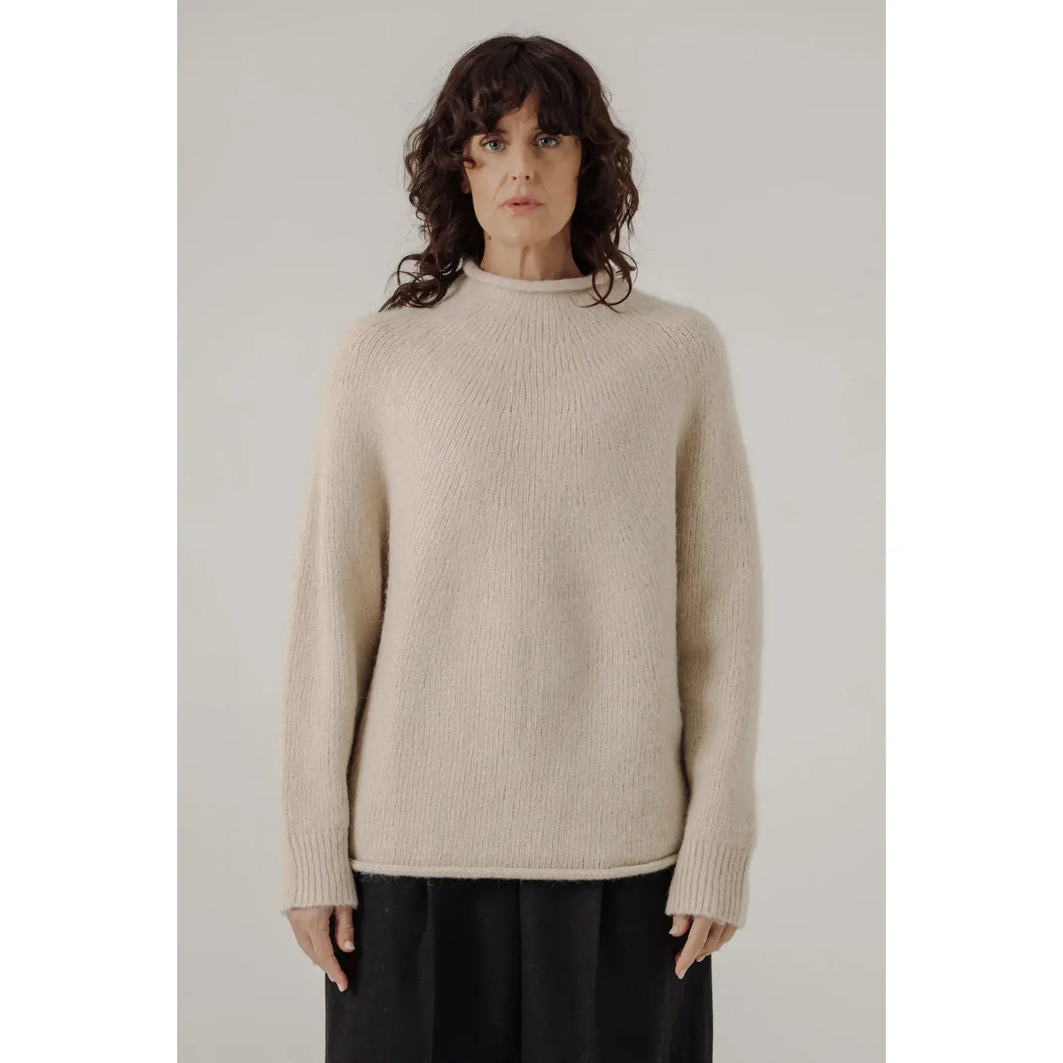 Women's cream handloom rollneck sweater by Bare Knitwear, featuring a cozy knit texture and classic fit.