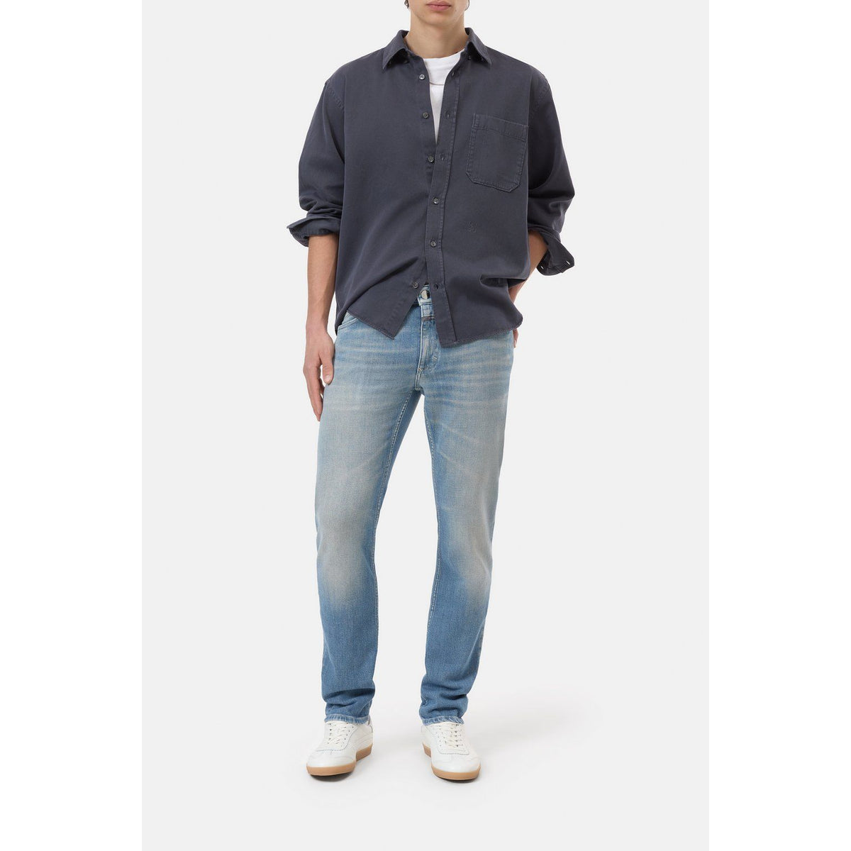 Men's Unity Slim Jean in mid blue from Closed Men's, showing the fit and denim texture on a well-fitted pair of jeans.