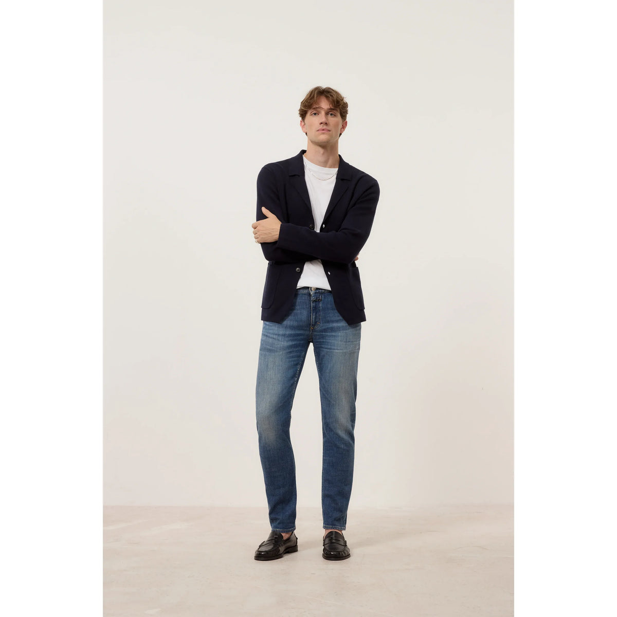 Men's mid blue Unity Slim Jean by Closed Men's, showing a close-up of the denim fabric and slim fit design.