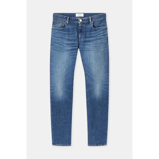 Men's Unity Slim Jean in mid blue from Closed Men's, showing the fit and classic denim style with visible stitching and front pockets.