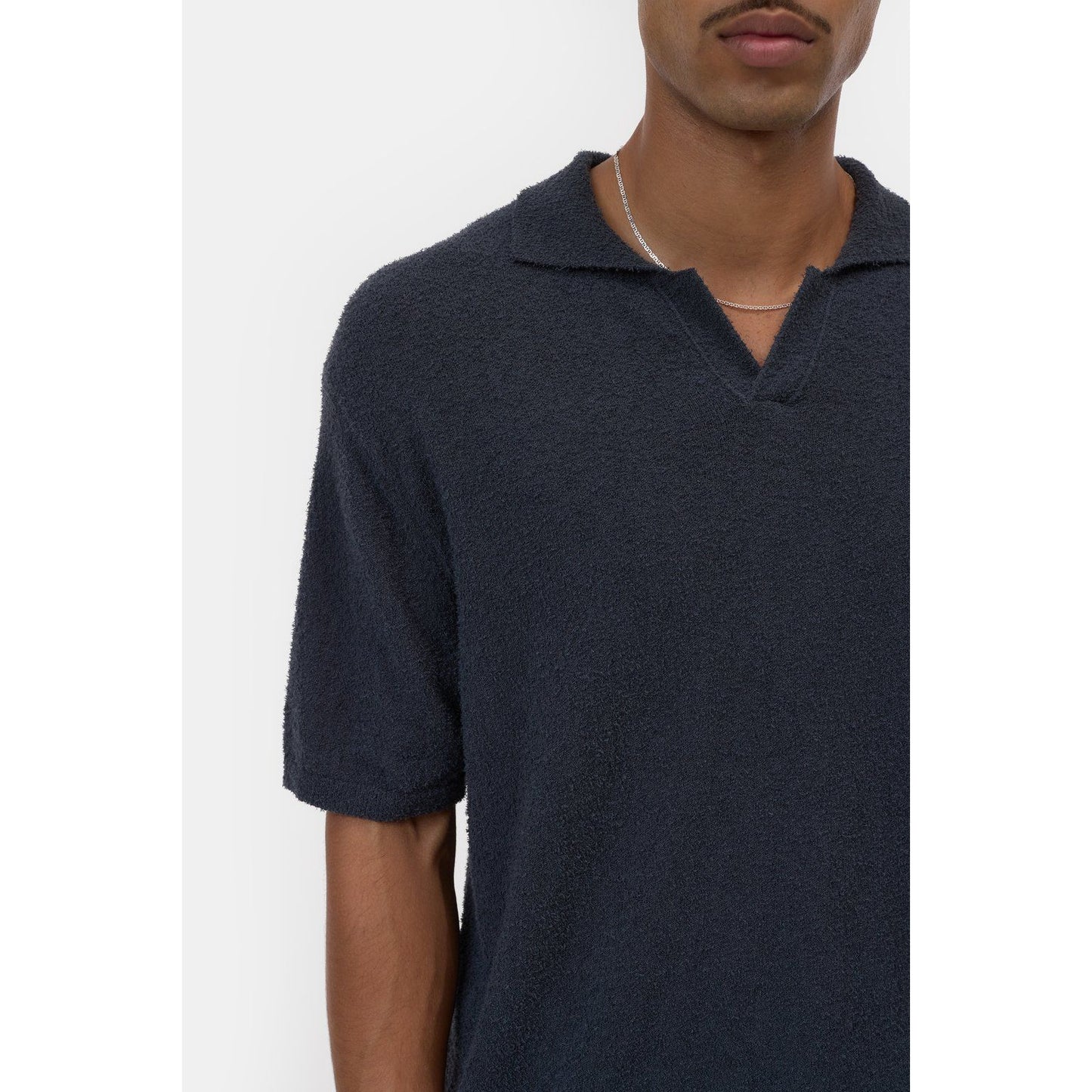 Men's cotton knit polo shirt in Magma Black by Closed Men's, featuring a classic collar and short sleeves.