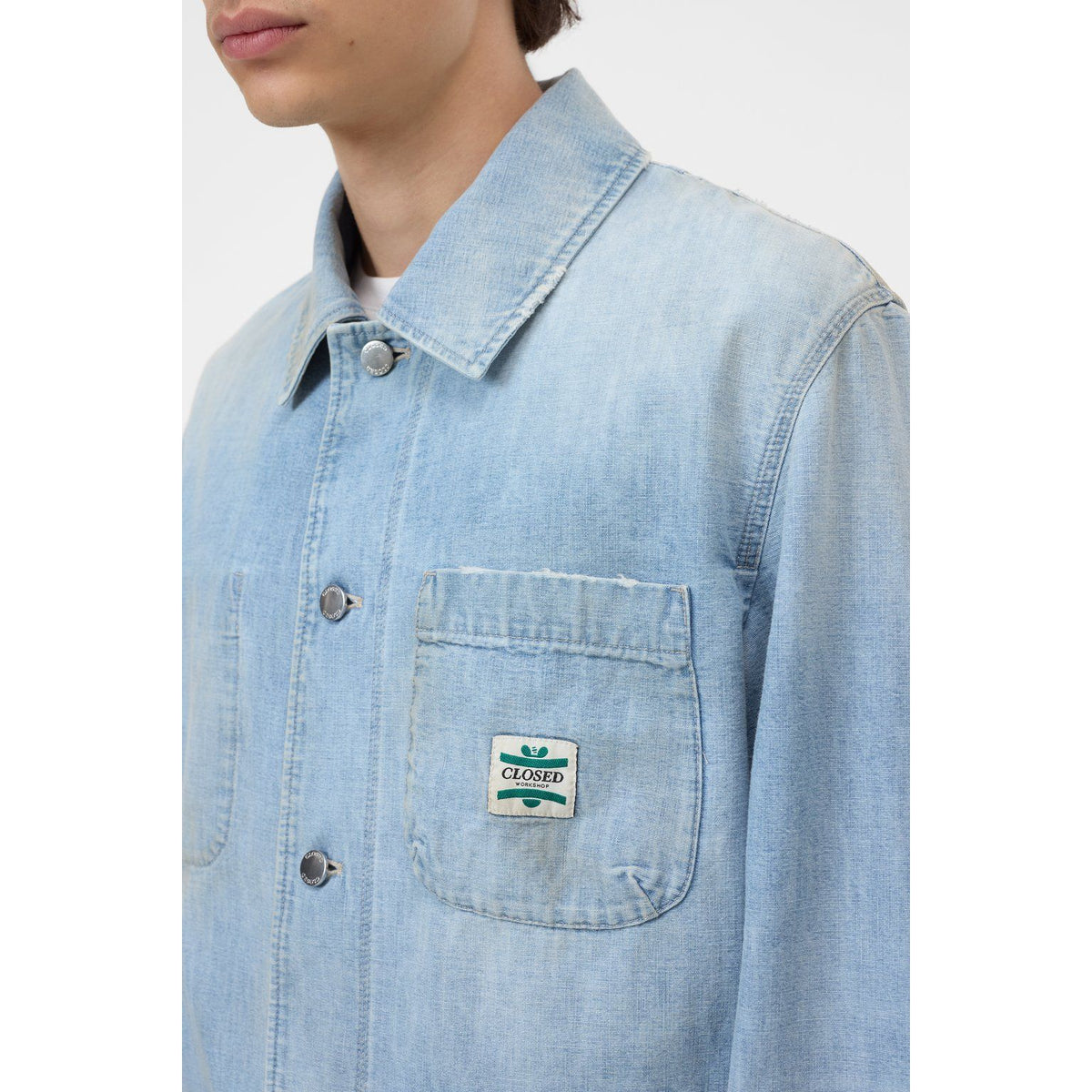 Men's light blue Worker denim jacket by Closed Men's, shown on a hanger with front view and classic denim details.