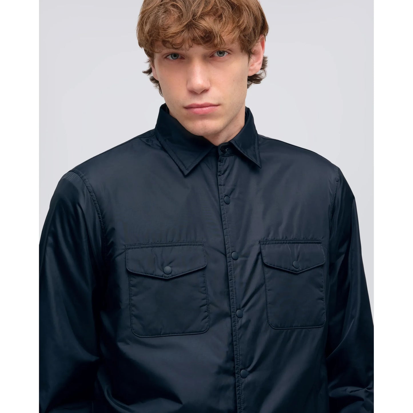 Men's navy 13 Piu shirt by Aspesi featuring a classic fit and soft cotton fabric, displayed on a hanger on a plain background.