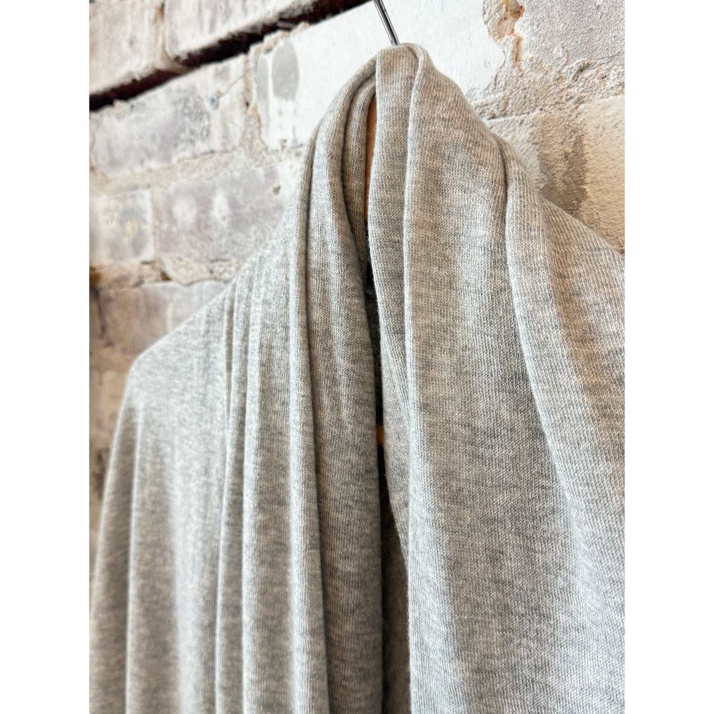 Women's washable cashmere shawl by Majestic Filatures in soft Brume Chine color, draped elegantly.