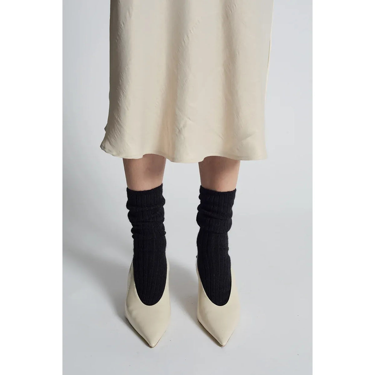 Black women's Ali Ribbed Socks by ELEVEN SIX, featuring a snug ribbed design and soft fabric for comfortable wear.