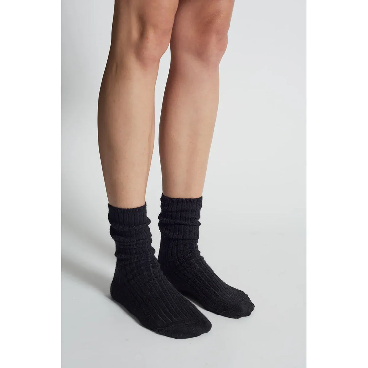Black women's Ali Ribbed Socks by ELEVEN SIX, showing the textured ribbed design and comfortable fit.
