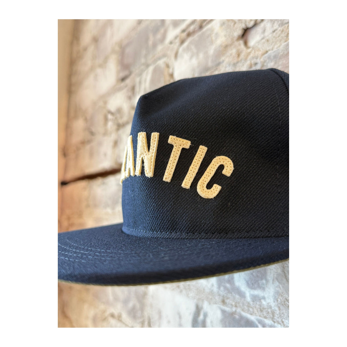 Men's Atlantic Snapback Hat in navy from The Ampal Creative featuring a structured cap with flat brim and adjustable strap.