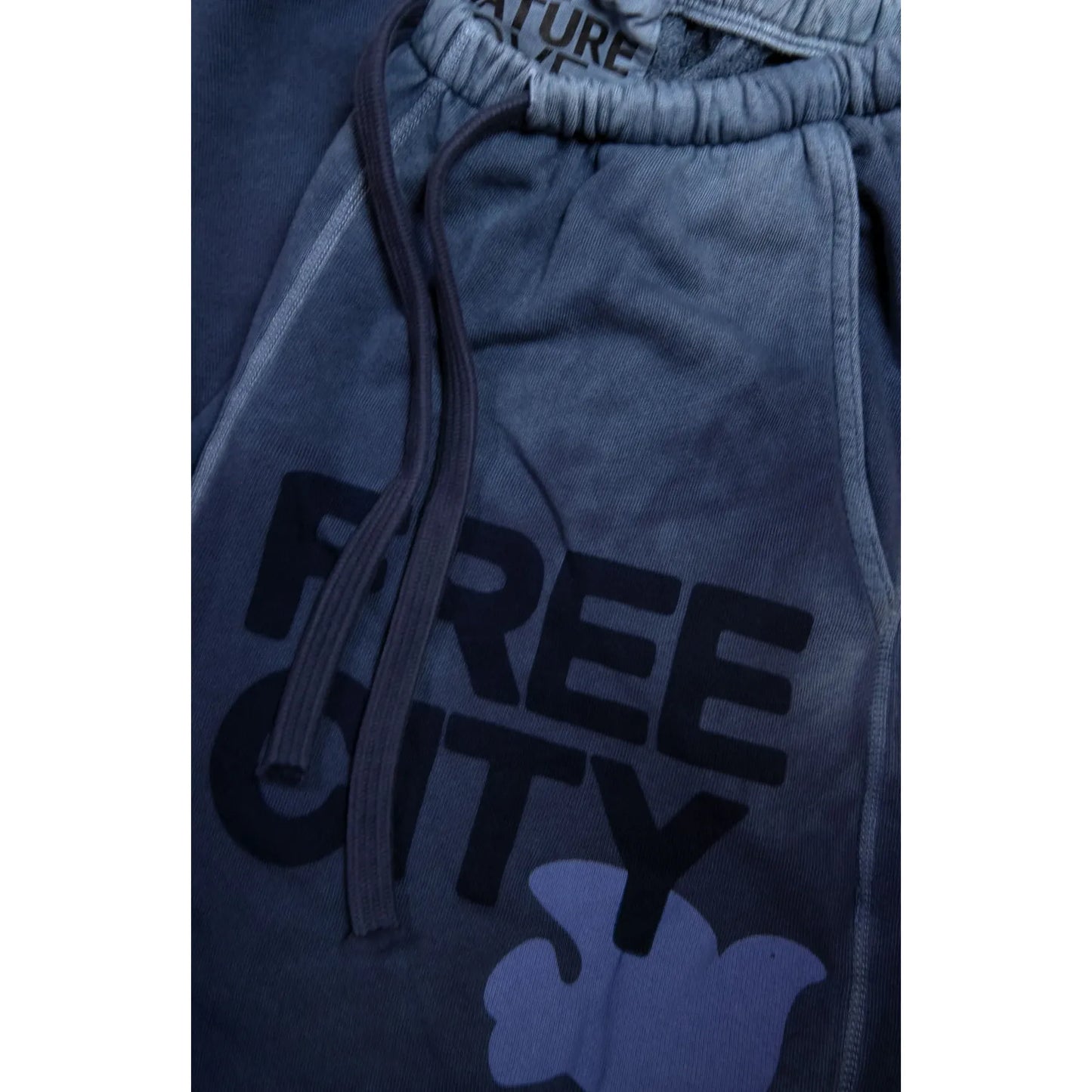 Women's Freecity large sunfades pocket sweatpants with moonshrooms print, relaxed fit, soft fabric, and side pockets.