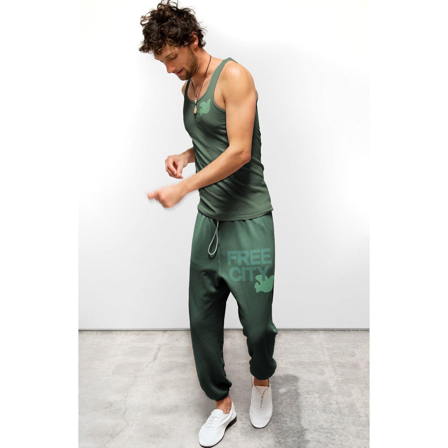 Women's Freecity large sweatpant in green, relaxed fit with elastic waistband and cuffs, made for comfortable casual wear.