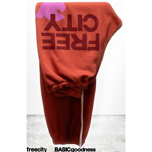 Women's Freecity large sweatpant in burn orange, relaxed fit with elastic waistband and cozy fabric for comfortable casual wear.