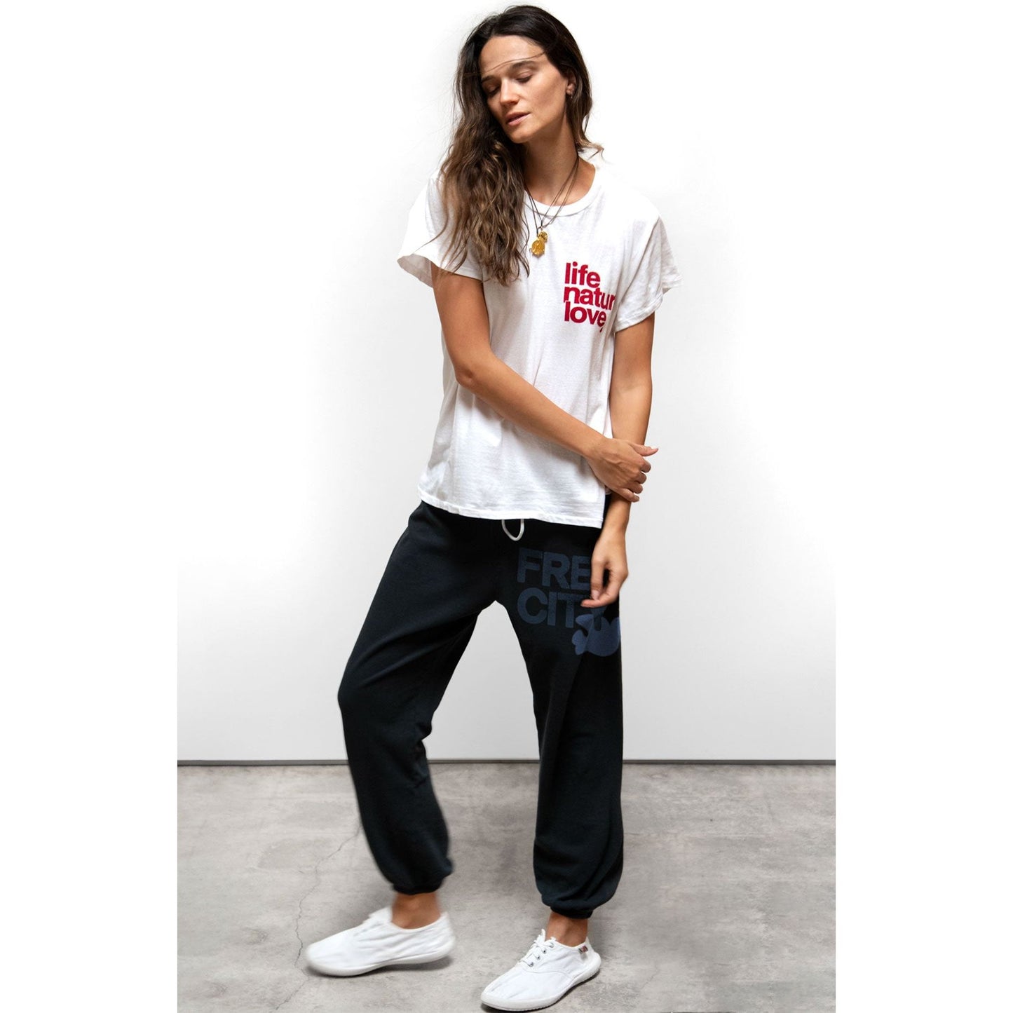 Women's Freecity large sweatpants in purple with bush print, comfortable relaxed fit and soft fabric.