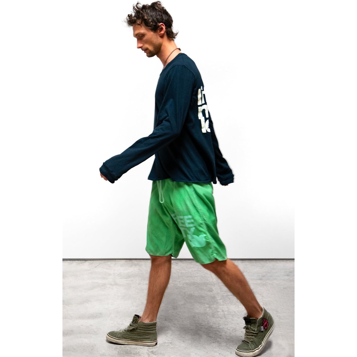 Women's Freecity matte satin back pocket shorts in Grasshopper Powder, showcasing the stylish design and fabric texture.