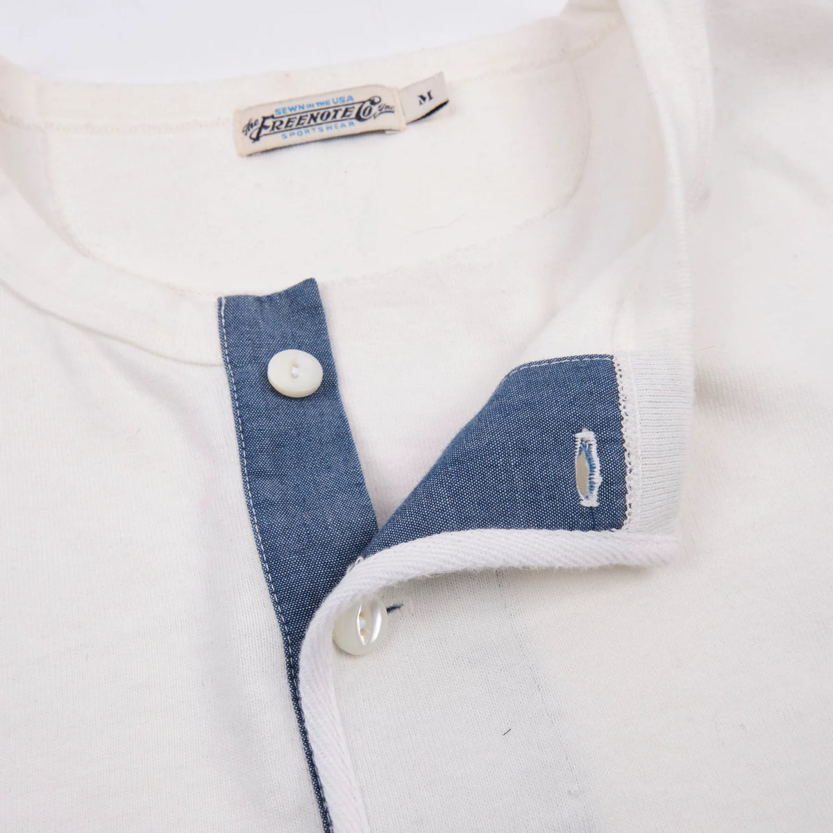 White men's 13 oz long-sleeve Henley shirt by Freenote Cloth, showcasing its classic style and soft fabric texture.