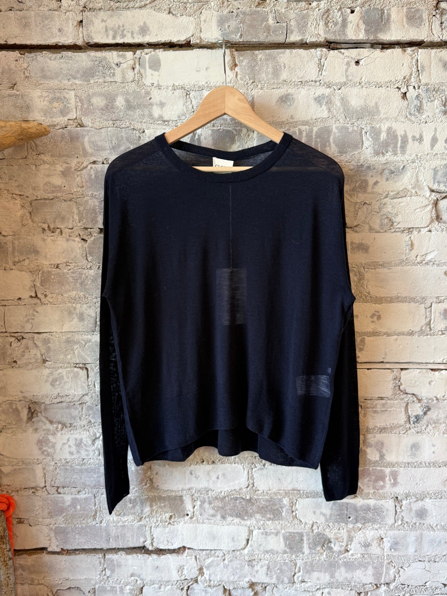 Close-up of a women's dark navy pure wool fine knit sweater by Closed Women's, showing soft textured fabric and fine stitching.