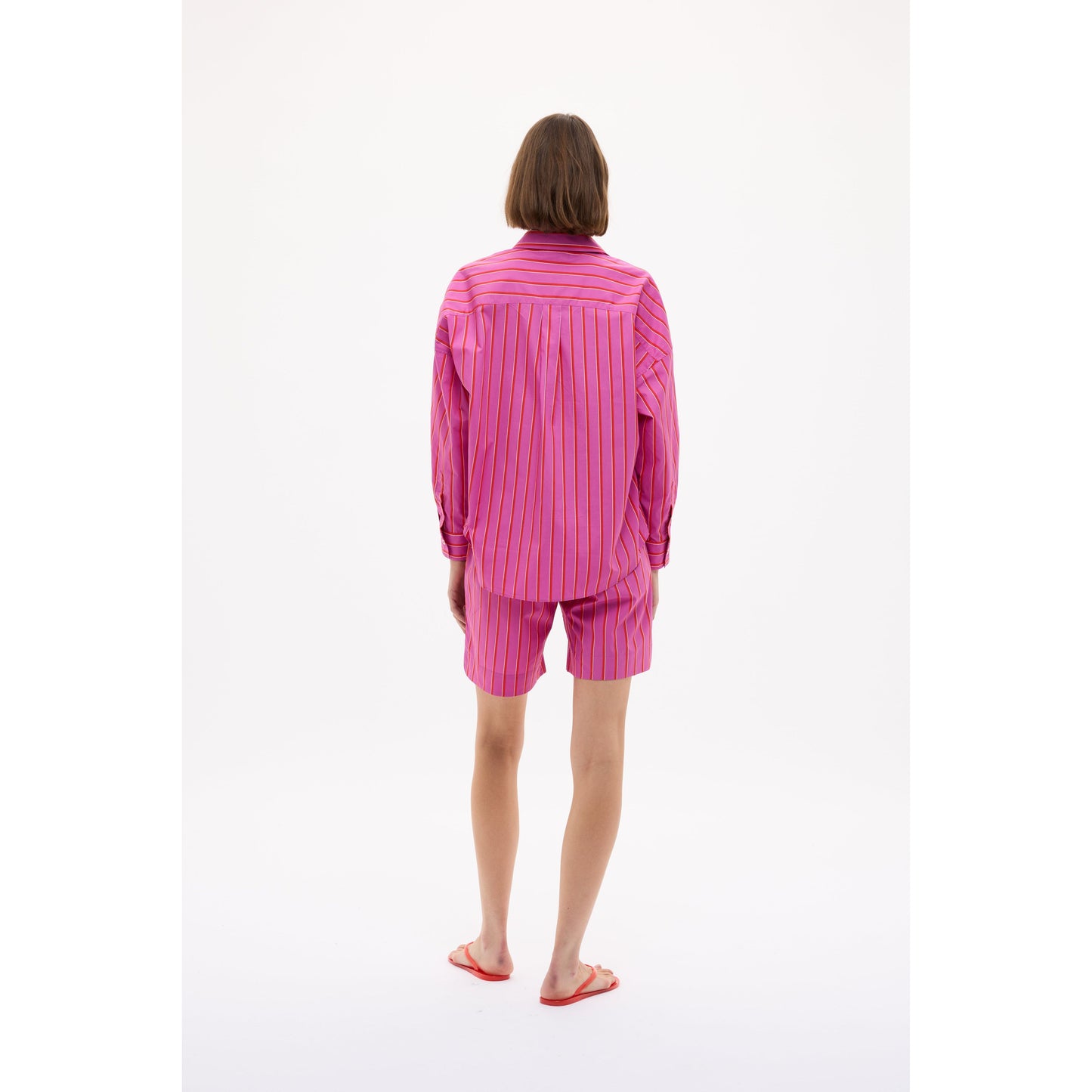 Women's Chiara Mid Length Short by LMND in fuchsia, true red, and natural stripe, showing the colorful fabric and fit.