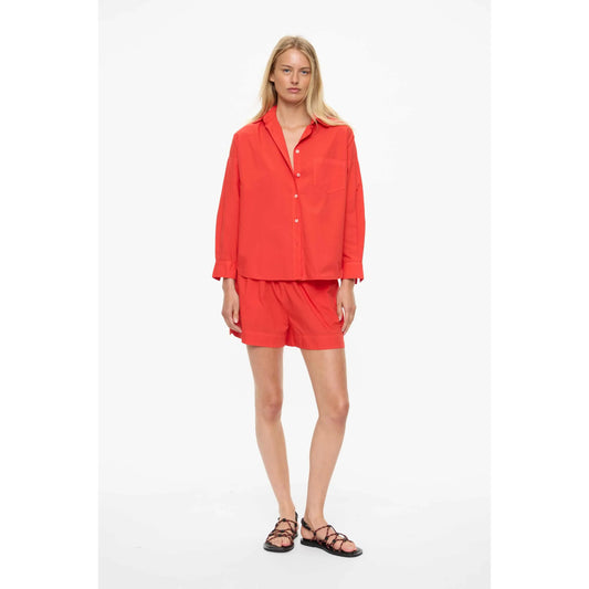 Women's Chiara Shirt in true red by LMND, featuring a stylish fit and vibrant color, shown on a model.