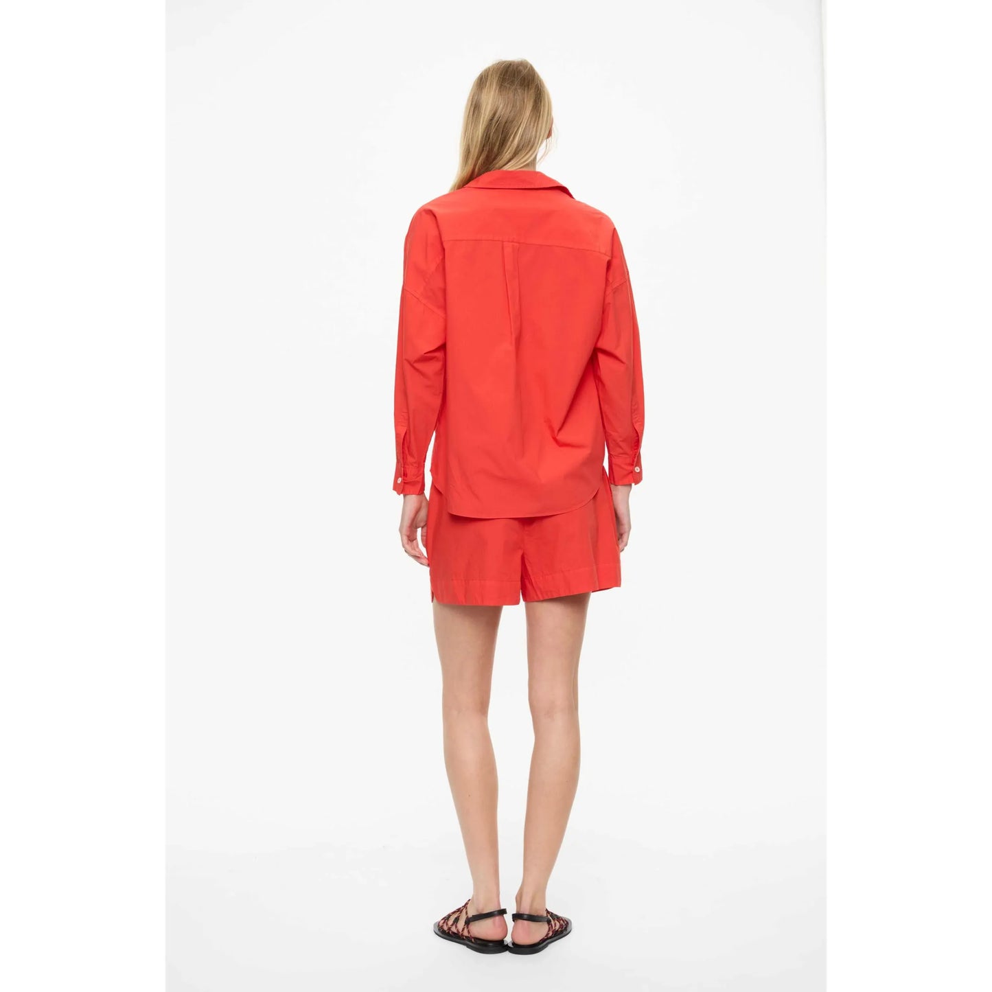 Women's Chiara Shirt in true red by LMND, featuring a stylish fit and classic design, shown on a model.