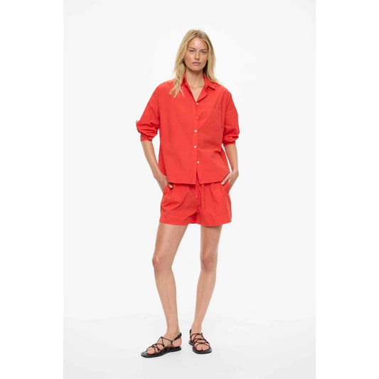Women's Chiara Shorts in true red by LMND, featuring a stylish fit and vibrant color, shown on a model.