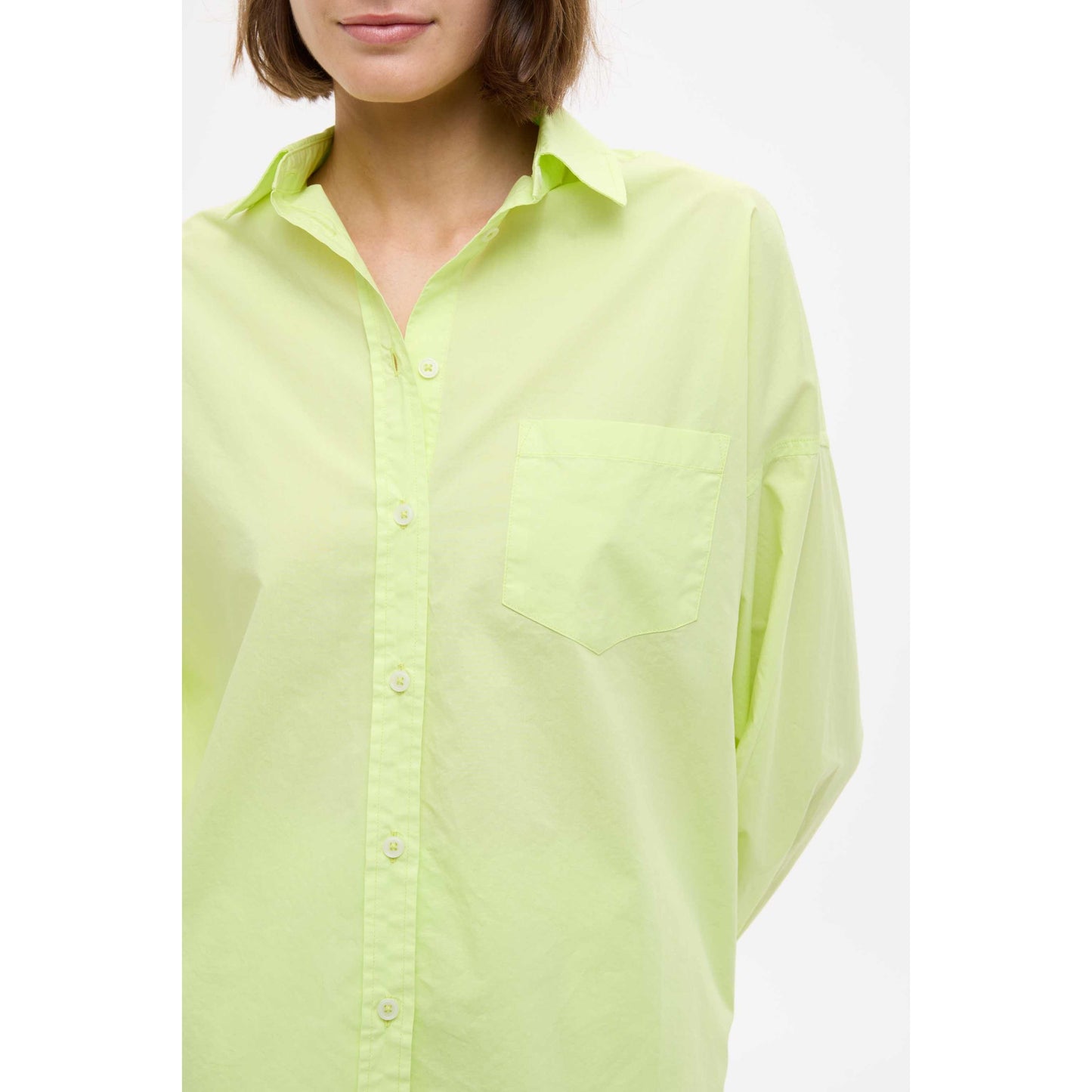 Women's Chiara Shirt in Sunny Lime by LMND, featuring a vibrant lime color and casual fit, displayed on a hanger.