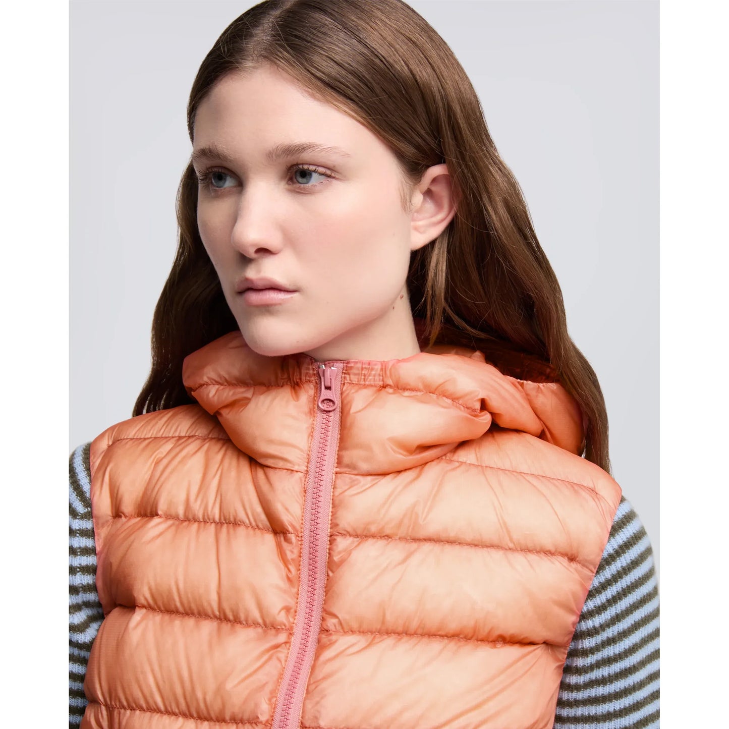 Women's powder pink Aspesi ultralight ripstop nylon vest shown on a model, lightweight and stylish for outdoor wear.