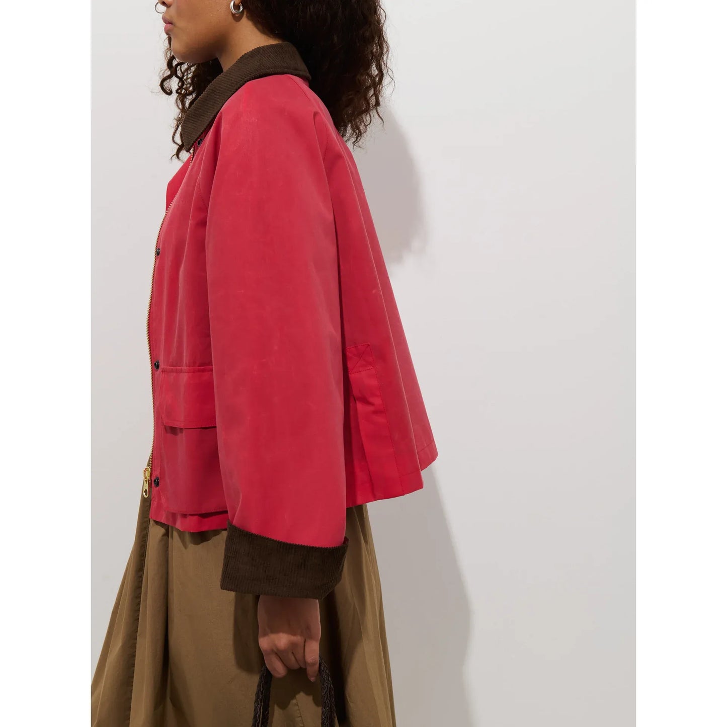 Women's Chiltern cropped jacket by Alex Mill in red waxed canvas, shown on a model with a close-up of the jacket's texture.