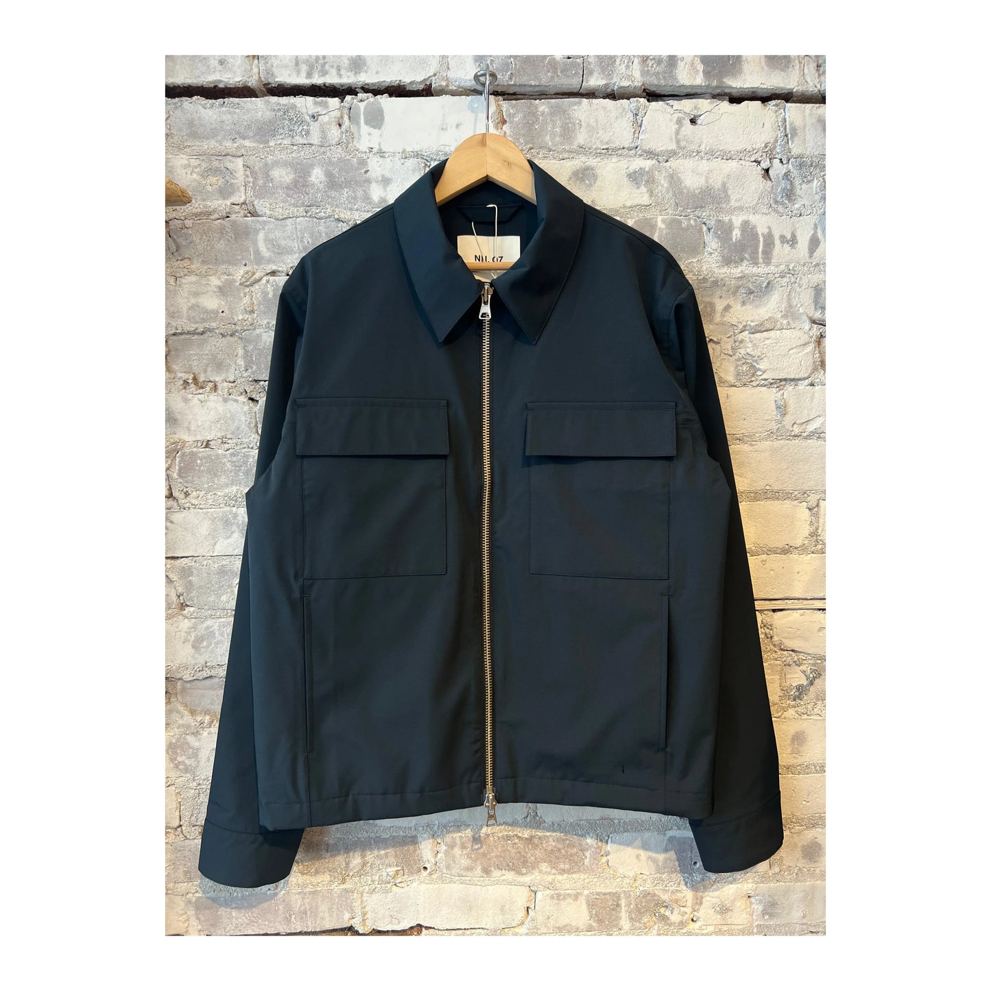 Men's navy blue Alban Technical Jacket by NN07, showcasing the lightweight, water-resistant outer layer with a full front zipper.