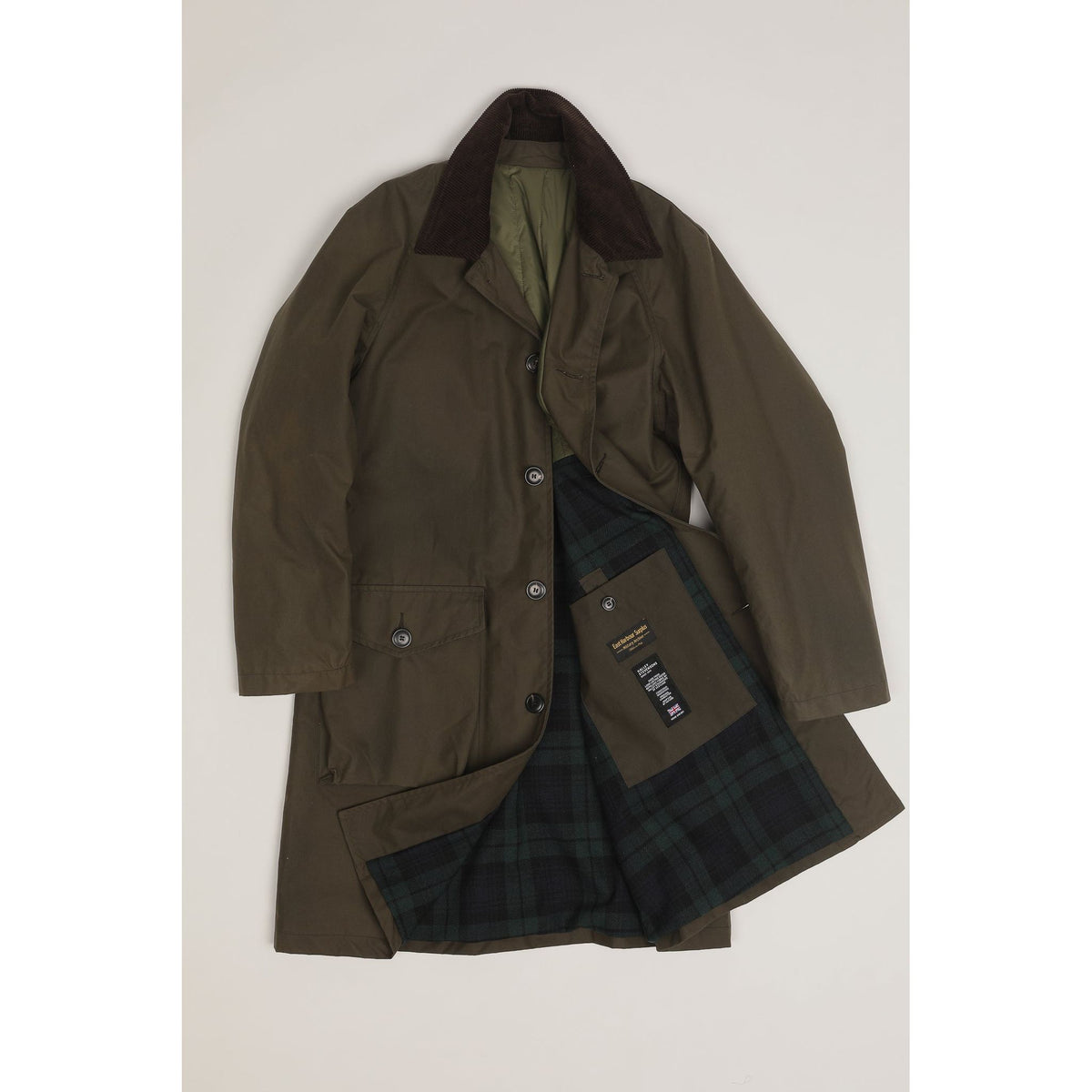 Men's green Baxter waxed cotton trench coat by East Harbour Surplus, featuring a classic design and durable waterproof material.