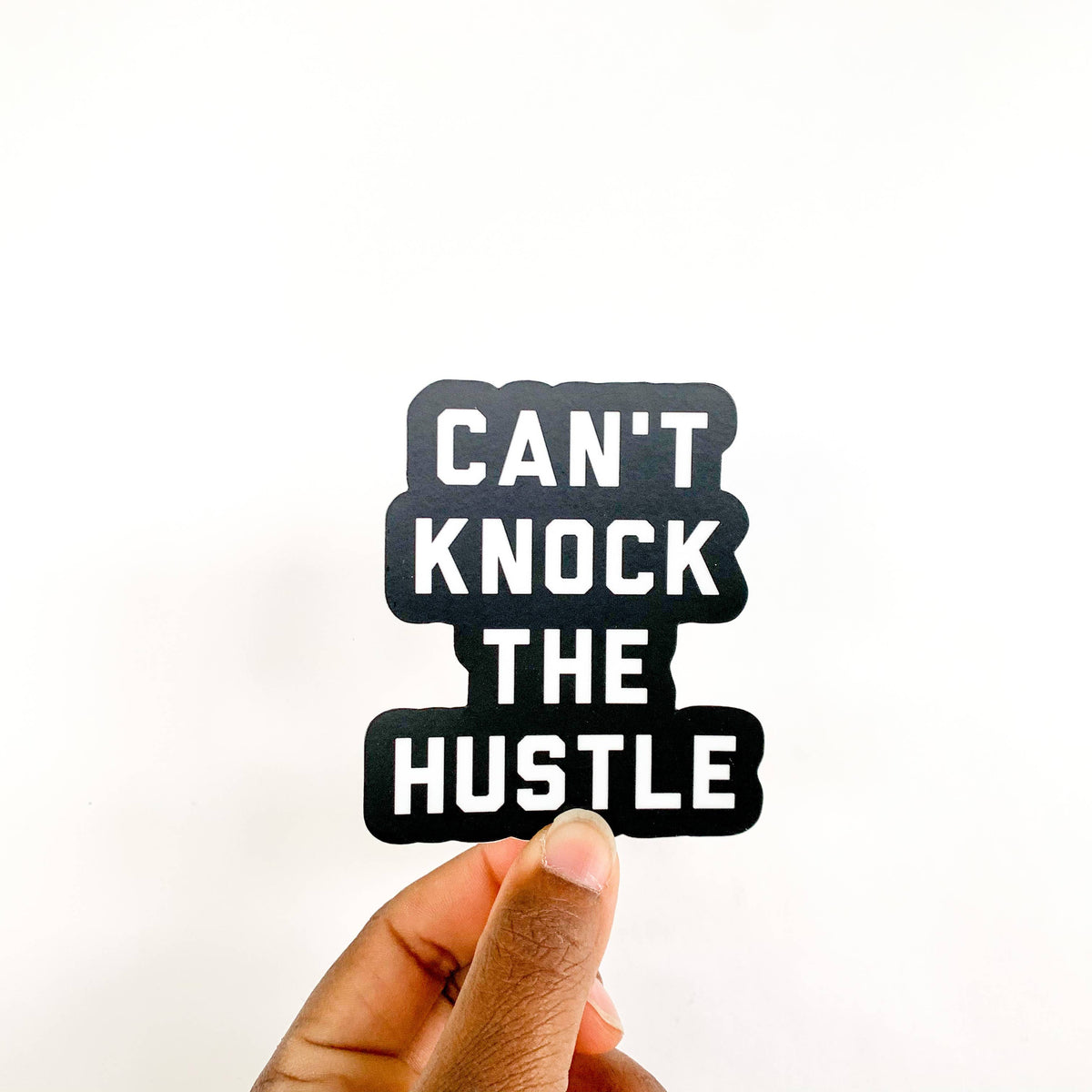 Can't Knock the Hustle sticker by N.B. GOODS, featuring bold text on a durable accessory sticker, perfect for personalizing items.