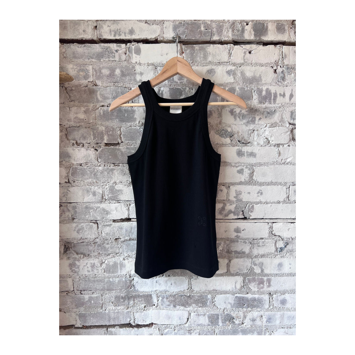 Black women's Racer Top by Closed Women's, close-up showing fitted sleeveless design and smooth fabric.