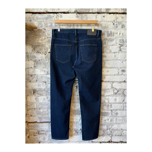Close-up of men's Cooper True Comfort Stretch Jeans in dark blue by Closed Men's, showing fabric texture and stitching details.