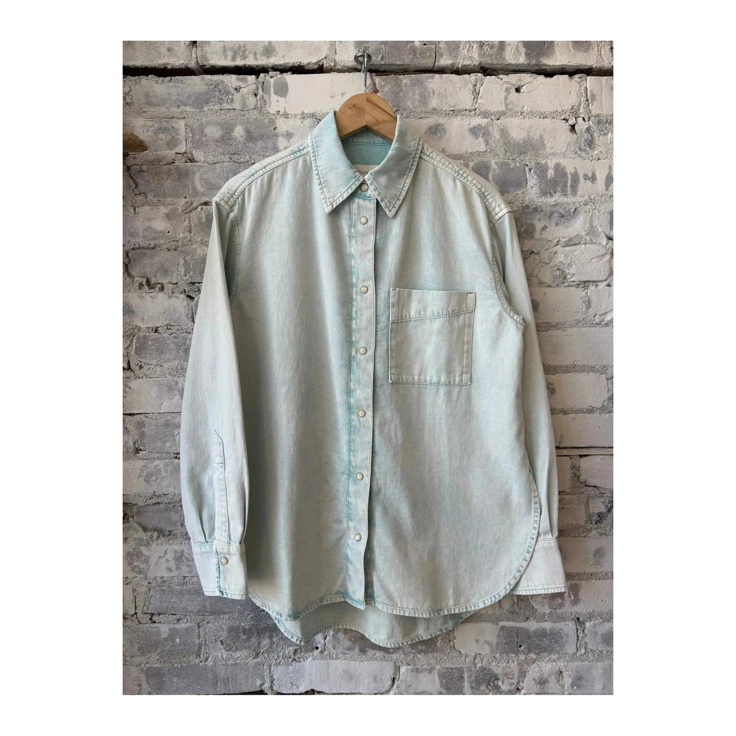 Women's washed out blue denim shirt by Closed Women's, showcasing the casual fit and classic button-front design.