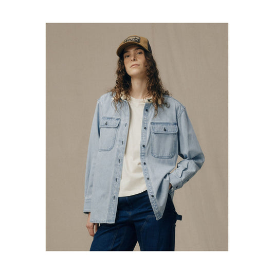 Women's light indigo denim work shirt by FILSON, showing front view with button closure and classic collar detail.