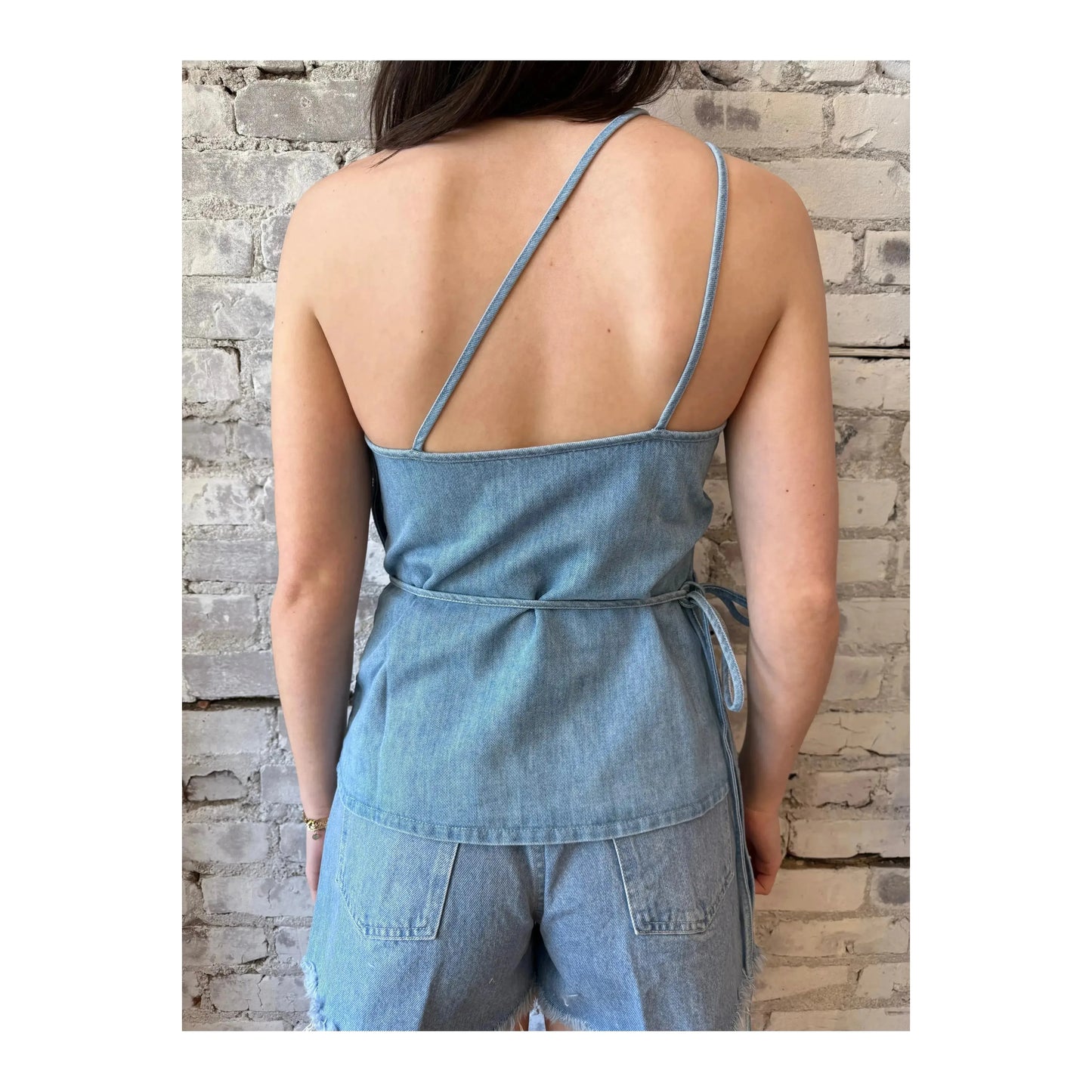 Light blue women's denim wrap top by Closed Women's, showcasing a stylish, fitted design with long sleeves and a flattering wrap silhouette.