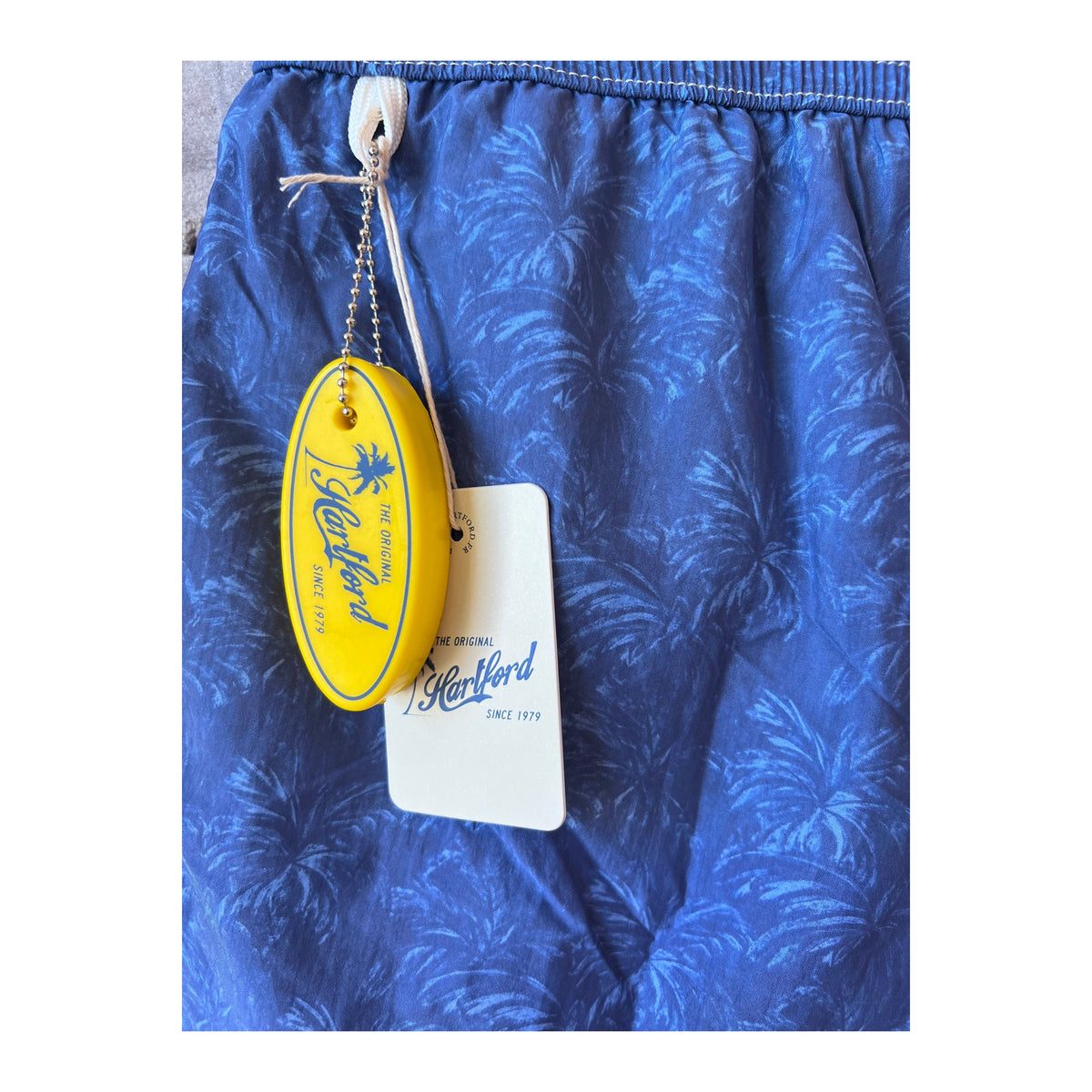 Men's Hartford Palms Print Nylon Swim Trunks in blue, featuring a vibrant tropical palm print and comfortable fit.