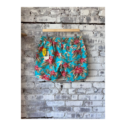 Men's printed turquoise swim trunks from Hartford Men's featuring a vibrant tropical pattern, suitable for beach or pool.