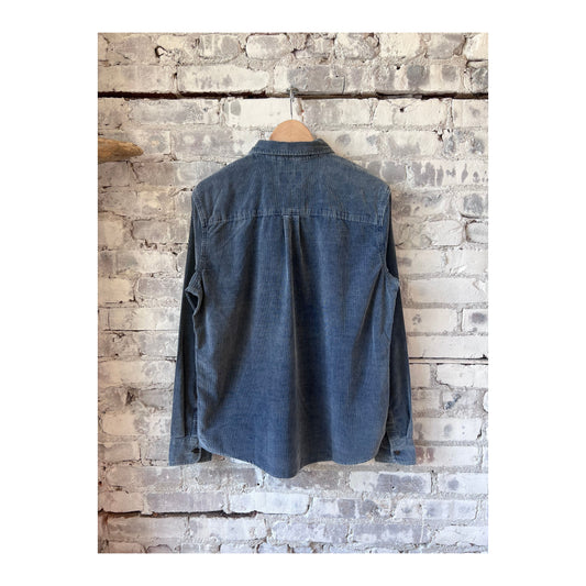 Men's lightweight indigo corduroy shirt by Marine Layer, showing the textured fabric and classic collar on a casual fit.